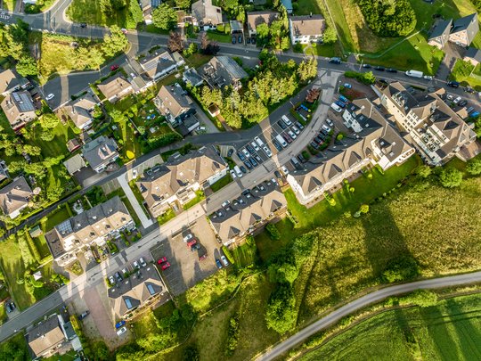 Ferienwohnungen in Gemünd mit dem gewissen Extra Luftaufnahme eines Wohngebiets mit Häusern, Autos und grünen Wiesen
